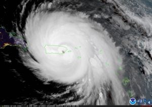 Satellite image of hurricane over green outlined Puerto Rico.